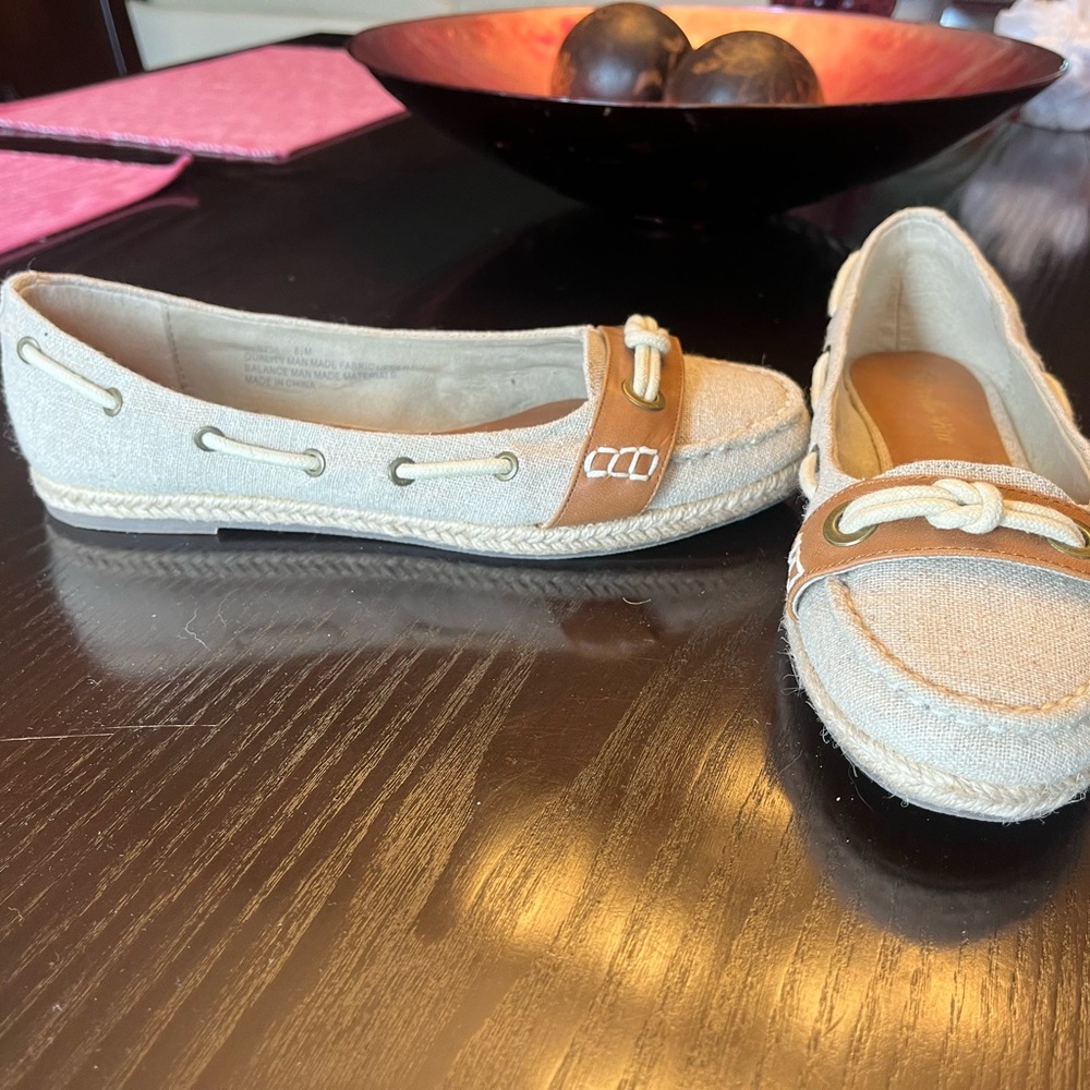 Super cute, casual boat shoes with tan leather appliqué. Pristine condition.